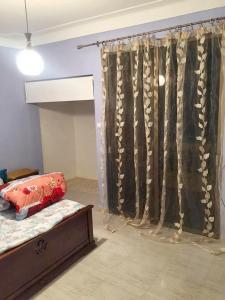 a bedroom with a bed and a window with a curtain at Stylish apartment in El Marsa 75 m² sea view in El Marsa