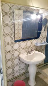 a bathroom with a white sink and a mirror at Stylish apartment in El Marsa 75 m² sea view in El Marsa +8 photos