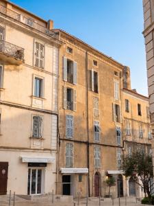 an old brick building in a city with at Appartement cosy à Bonifacio avec vue sur la mer - 45 m² in Bonifacio