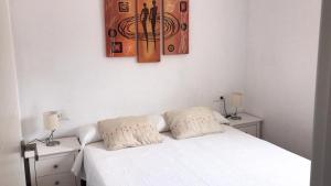 a bedroom with a white bed with two pillows on it at Seaside Villa in Calafat with Private Pool. in Calafat