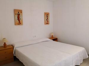 a bedroom with a white bed and two nightstands at Seaside Villa in Calafat with Private Pool. in Calafat