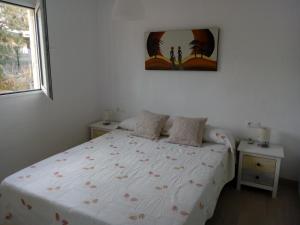 a bedroom with a large white bed with flowers on it at Seaside Villa in Calafat with Private Pool. in Calafat