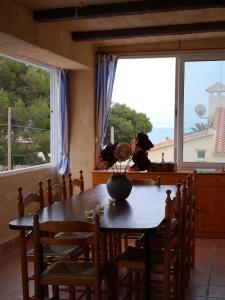 a dining room with a table and a large window at Seaside Villa in Calafat with Private Pool. in Calafat