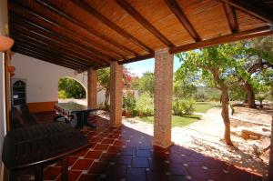 a patio with a ping pong table in a house at Rustic Villa Tavira with Mountain Views and Pool in Tavira