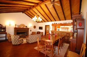 a living room with a table and a dining room at Rustic Villa Tavira with Mountain Views and Pool in Tavira