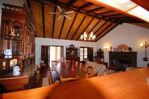 a dining room with a table and a ceiling fan at Rustic Villa Tavira with Mountain Views and Pool in Tavira