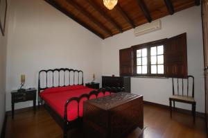 a bedroom with a bed and a table and a window at Rustic Villa Tavira with Mountain Views and Pool in Tavira