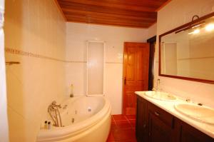 a bathroom with a tub and a sink at Rustic Villa Tavira with Mountain Views and Pool in Tavira +19 photos