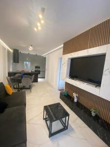 a living room with a large flat screen tv at Apartamente Arad Premium in Arad