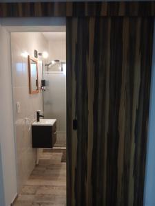 a bathroom with a sink and a mirror at Los Aromos Carhue in Carhué