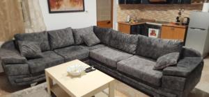 a living room with a gray couch and a table at Villa Star in Tirana