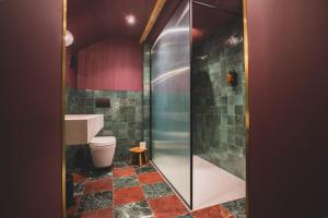a bathroom with a toilet and a glass shower at The Linen Rooms in Knutsford +71 photos