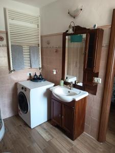 a bathroom with a washing machine and a sink at La Tavernetta in Ponte della Venturina +30 photos