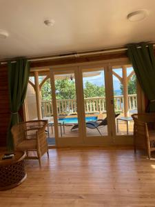 a screened in porch with sliding glass doors at Hôtel Hamaha Beach in Mamoudzou