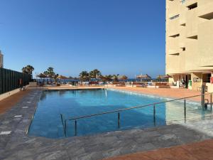 a large swimming pool next to a building at ESTUDIOS CHINASOL - Bernardo Cózar in Almuñécar