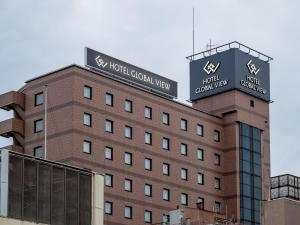 a building with a sign on top of it at Hotel Global View Nagaoka in Nagaoka