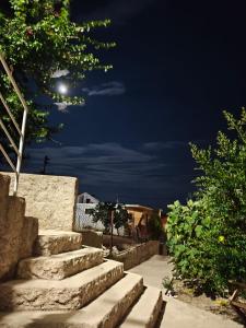 a set of stone stairs at night at Apartmans White perl in Sutomore