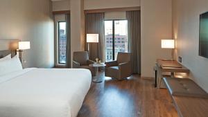 a hotel room with a bed and a desk at AC Hotel by Marriott Minneapolis Downtown in Minneapolis