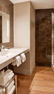 a bathroom with a sink and a shower at AC Hotel by Marriott Minneapolis Downtown in Minneapolis