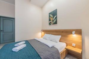 ein Schlafzimmer mit einem Bett, auf dem zwei weiße Handtücher liegen in der Unterkunft Mini hotel Non-Stop in Kiew