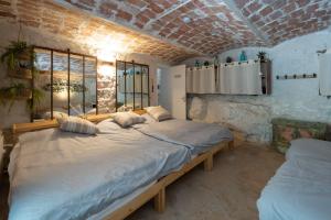 a bedroom with a large bed in a room at Maison Henriette - Authentique maison ardéchoise in Labeaume +7 photos