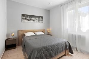 a bedroom with a bed and a large window at Villa Hacienda piscine et terrasse in Vidauban +20 photos