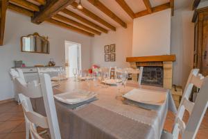 a dining room with a table and chairs and a fireplace at Chez annie in Onjon