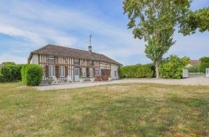 an old house with a tree and a grass field at Chez annie in Onjon