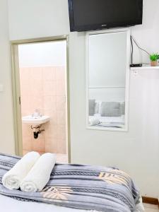a bedroom with a bed with a sink and a mirror at Paradise Corner in Francistown