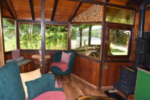 a room with chairs and a stove in a train car at ECO cabin Plivsko jezero Jajce in Jajce