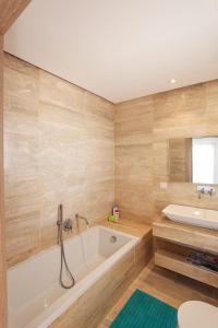a bathroom with a tub and a sink at La Brise De Gammarth in Gammarth