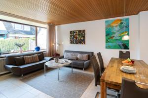 a living room with a couch and a table at Sonneneck in Westerland