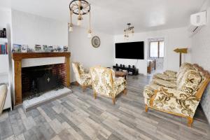 a living room with a couch and a fireplace at Gite grande capacité en Puisaye in Breteau