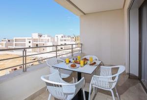 a table with a plate of food on a balcony at La Brise De Gammarth in Gammarth