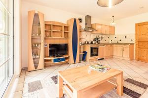 a large kitchen with a table and a surfboard at Wiesenglück in Abtsgmünd
