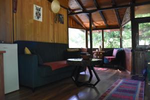 a living room with a couch and a table at ECO cabin Plivsko jezero Jajce in Jajce