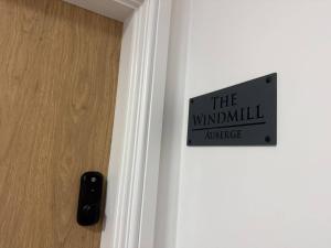 a sign on a door that reads the windmillnance at Auberge Hotel by Sasco in Lytham St Annes
