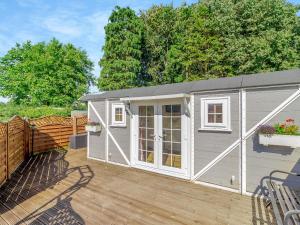a large white shed on a wooden deck at Lovers Carriage - Uk46404 in Cowbridge +5 photos
