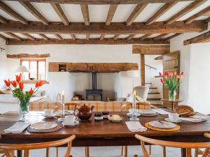 a dining room with a wooden table and chairs at Blaenau - Uk50400 in Llanstephan