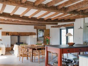 a living room with wooden ceilings and a table and chairs at Blaenau - Uk50400 in Llanstephan