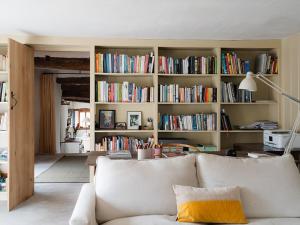 a living room with a couch and a book shelf filled with books at Blaenau - Uk50400 in Llanstephan