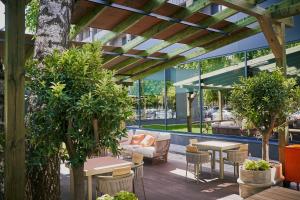 a patio with tables and chairs in a building at Mimi Hotel Chisinau Jolly Alon in Chişinău