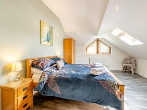 a bedroom with a large bed and a wooden dresser at Derwen Haidd in Llanafan