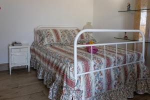 a bedroom with a bed with a bedspread on it at Courtyard T0 Studio Farmhouse in Idanha-a-Nova +35 photos
