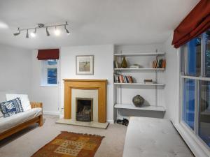 a living room with a fireplace and a couch at Sheldon Cottage in Bishops Castle