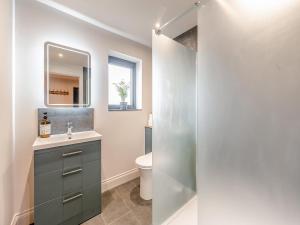 a bathroom with a sink and a toilet at Maple Barn in Eye
