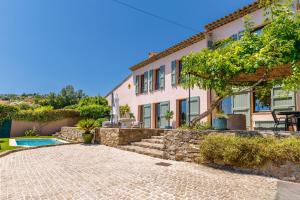 a villa with a swimming pool and a house at Villa Flore - Panoramic Sea View by Halldis in Vallauris