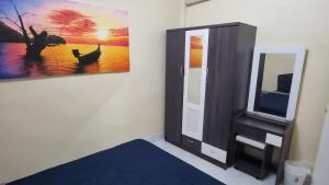 a room with a tv and a painting on the wall at La Belle Cliff View in Ao Nang Beach