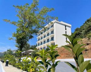 a white building on the side of a hill at Swiss Rivage Hotel in Vlorë