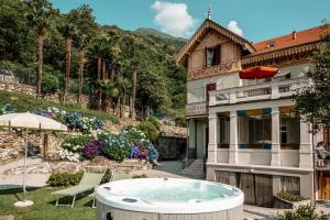 a house with a hot tub in the yard at Ca Meison in Cannobio
